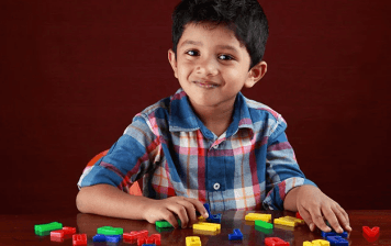 Image of boy phonics with alphabet letters